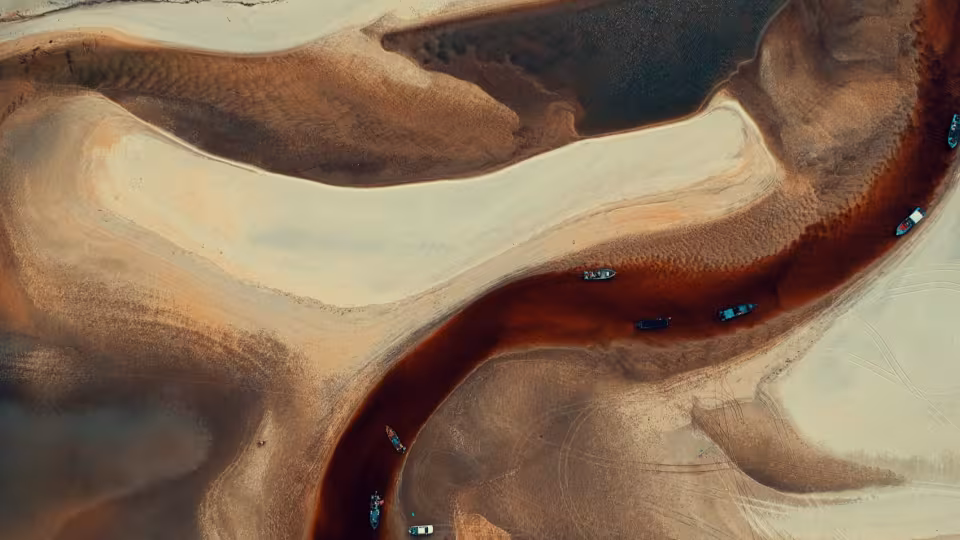 Canva-Aerial-photography-of-Boats-on-River-Surrounded-by-Desert