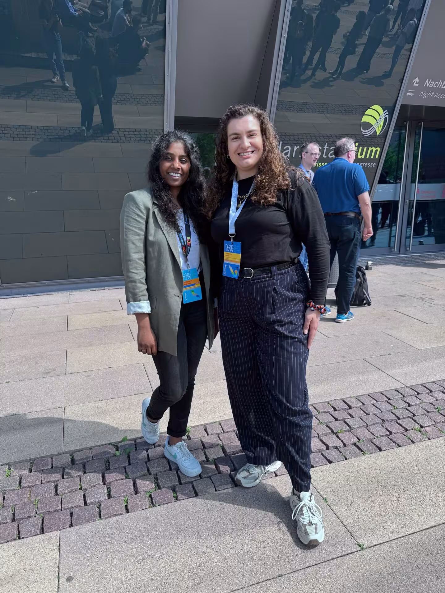 Two woman are standing in front of darmstadtium