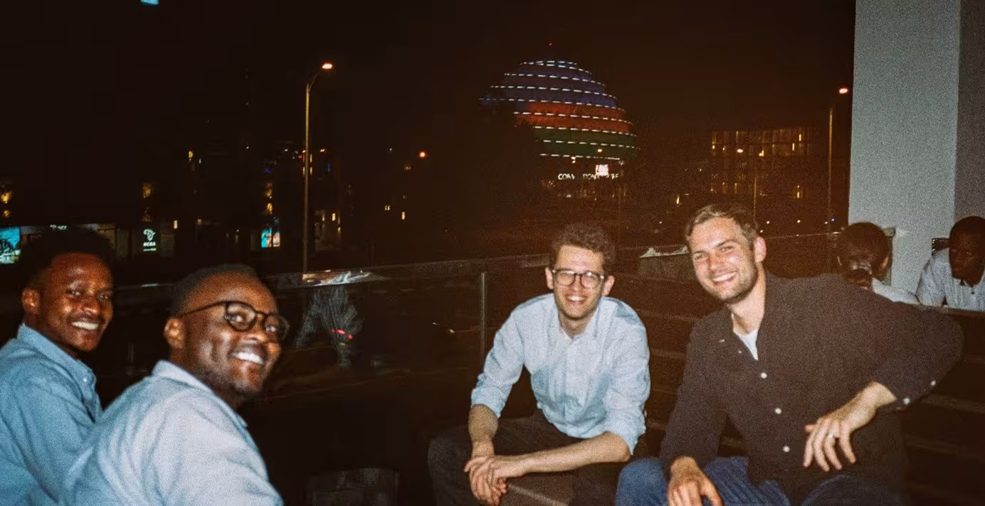 4 people smiling towards camera