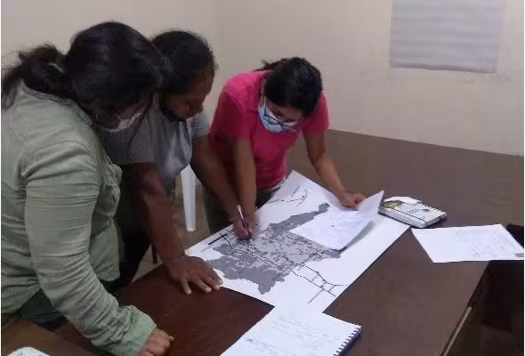 three women observing map